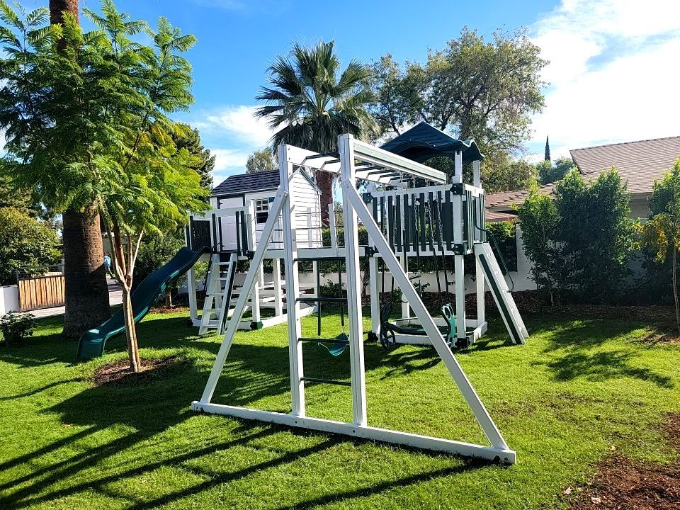 The perfect swing set with a attached kid's playhouse